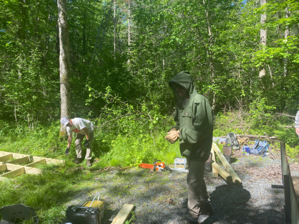 Volunteer showing off his gear to keep the bugs away