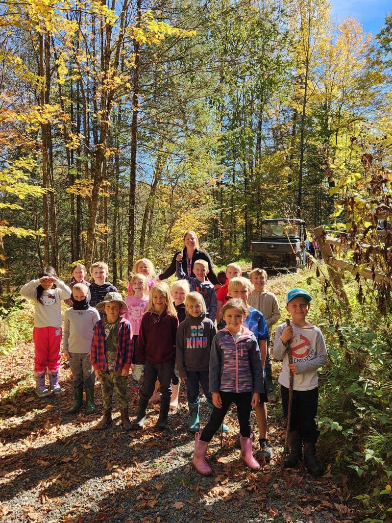 Mrs. Paul and her 1st grade students in the forest