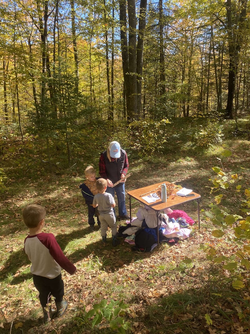 Elementary students learning about bark on three branches