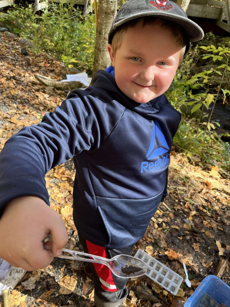 Elementary Student showing off his bug catch