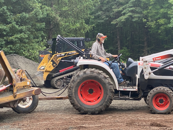 Rollie hauling gravel with the tractor