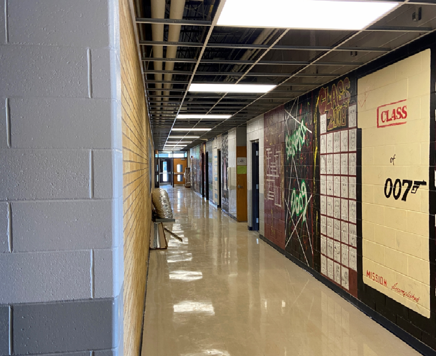 Ceiling grid and border are getting installed in the high school corridors.