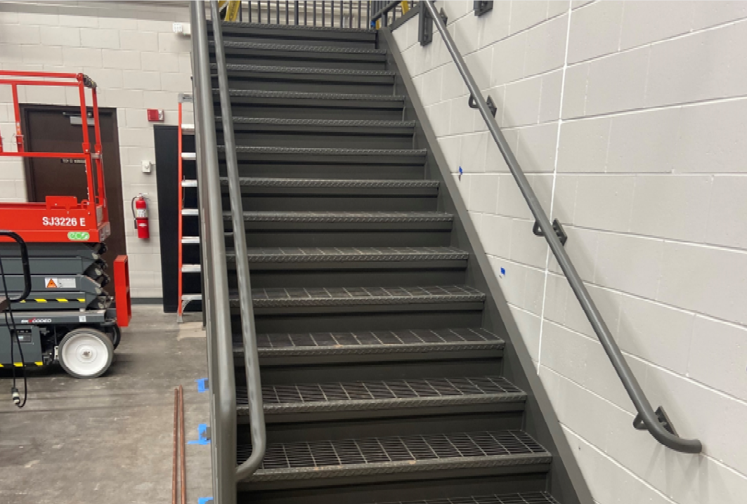 The stairway in the wood shop has received its final coat of paint.