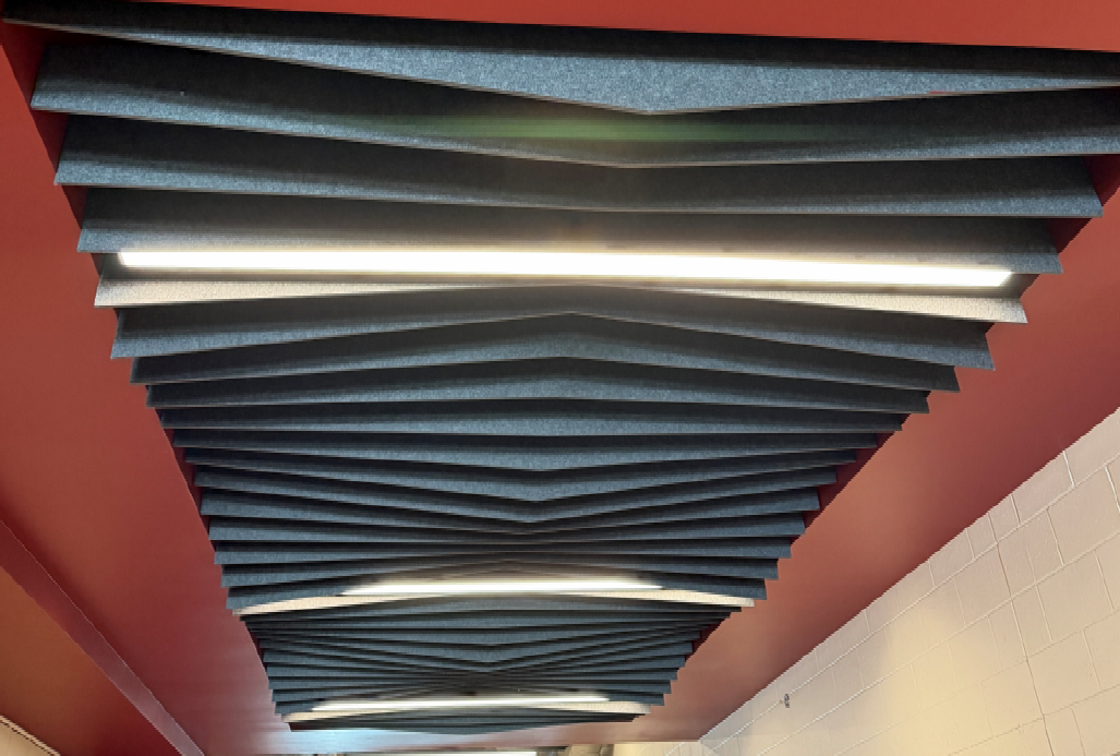 The acoustical accent ceiling has been installed above the trophy case