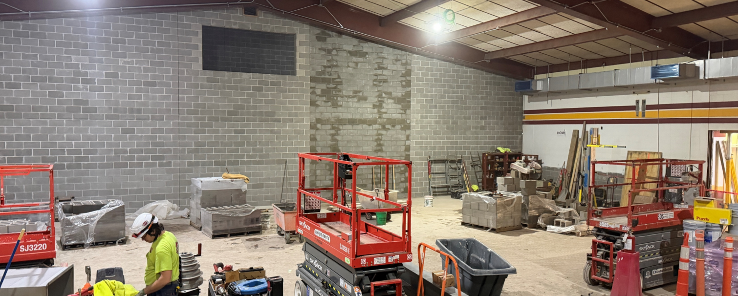 A view from the stage looking out towards the future cafeteria and new sound mezzanine under construction.